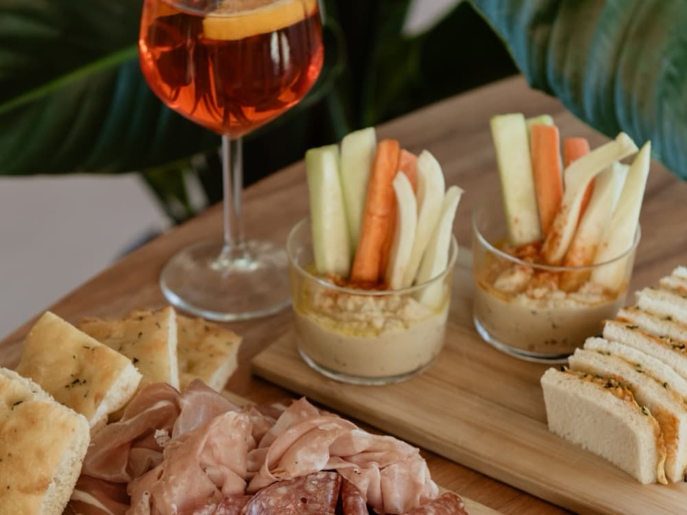 Drinks at WAO Kitchen: a spritz, hummus with crudites, focaccia and sandwiches