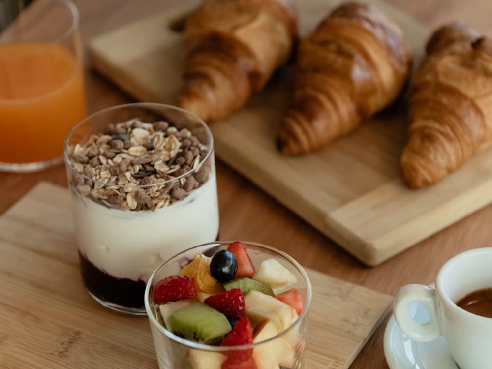 Breakfast at WAO Kitchen: yoghurt with granola, fruit salad, croissants, orange juice and espresso